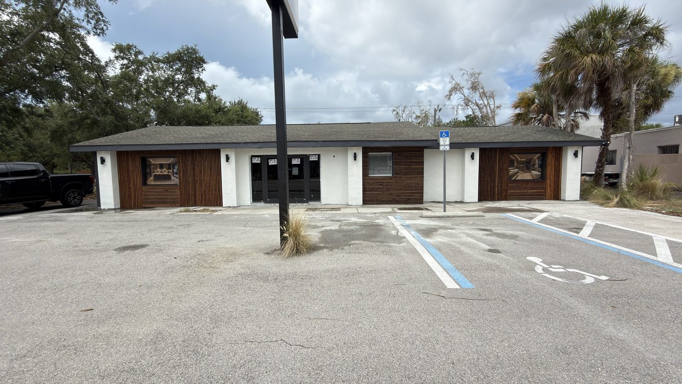 The same commercial building after full reconstruction, with new envelope, windows, and entry