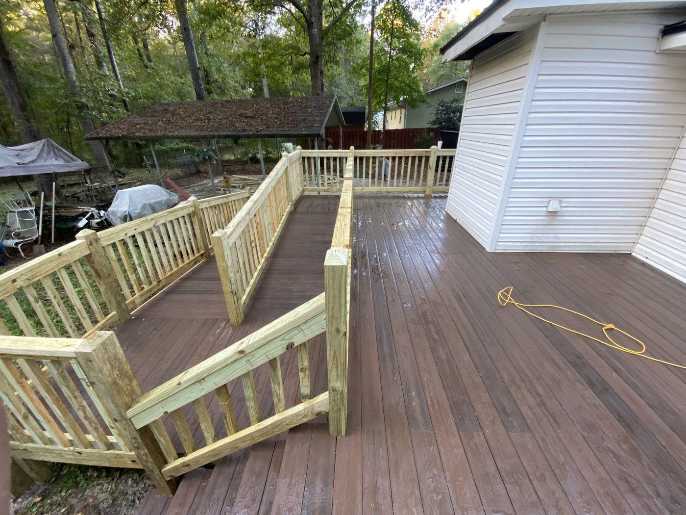 Stained deck with bench seating overlooking the yard