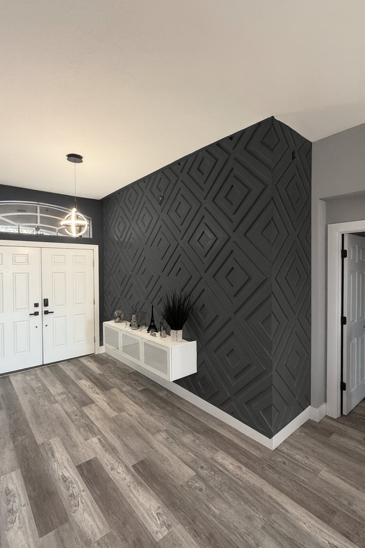 Charcoal entry wall with a raised diamond panel pattern