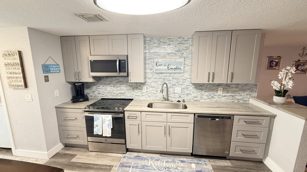 Kitchen remodel with grey shaker cabinets and mosaic backsplash